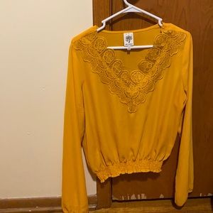 Golden blouse with floral neckline